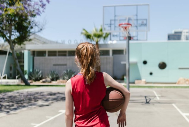 child carrying a basketball